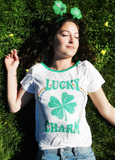 Lucky charm graphic tee with Shamrock & rainbow on a white and green ringer.